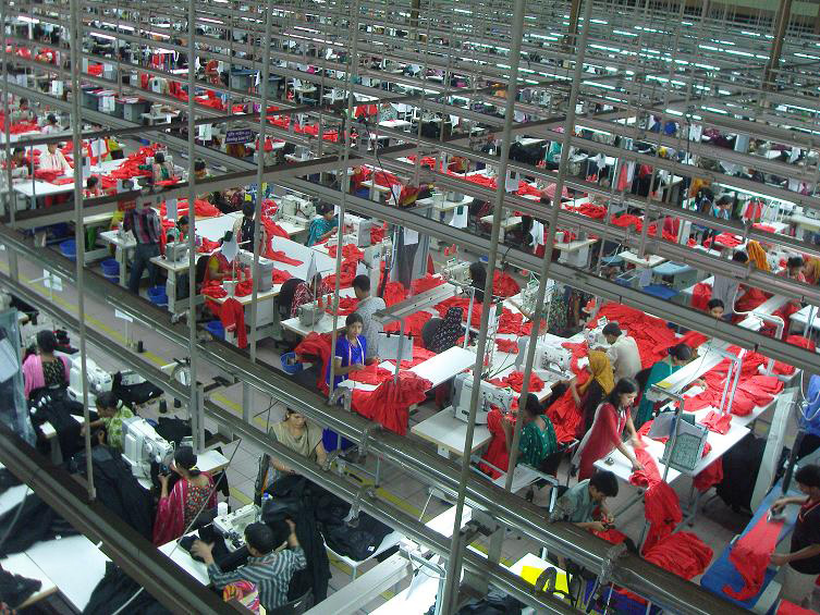 Garment workers sewing hoodies in a modern clothing factory in Bangladesh