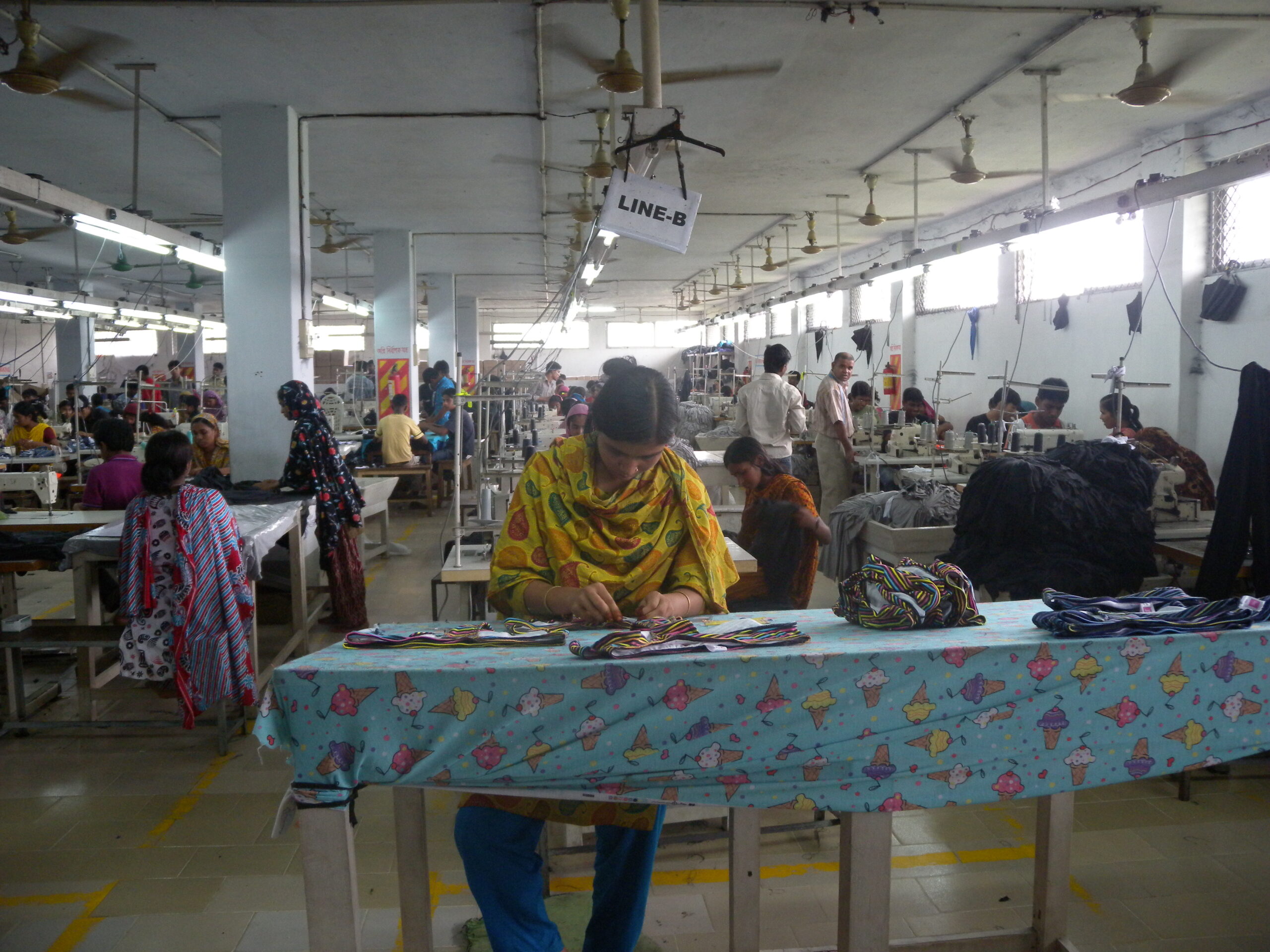 Workers at sewing machines in a Bangladesh garment factory producing apparel for export