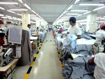 Garment factory production line with workers sewing apparel in Bangladesh manufacturing facility