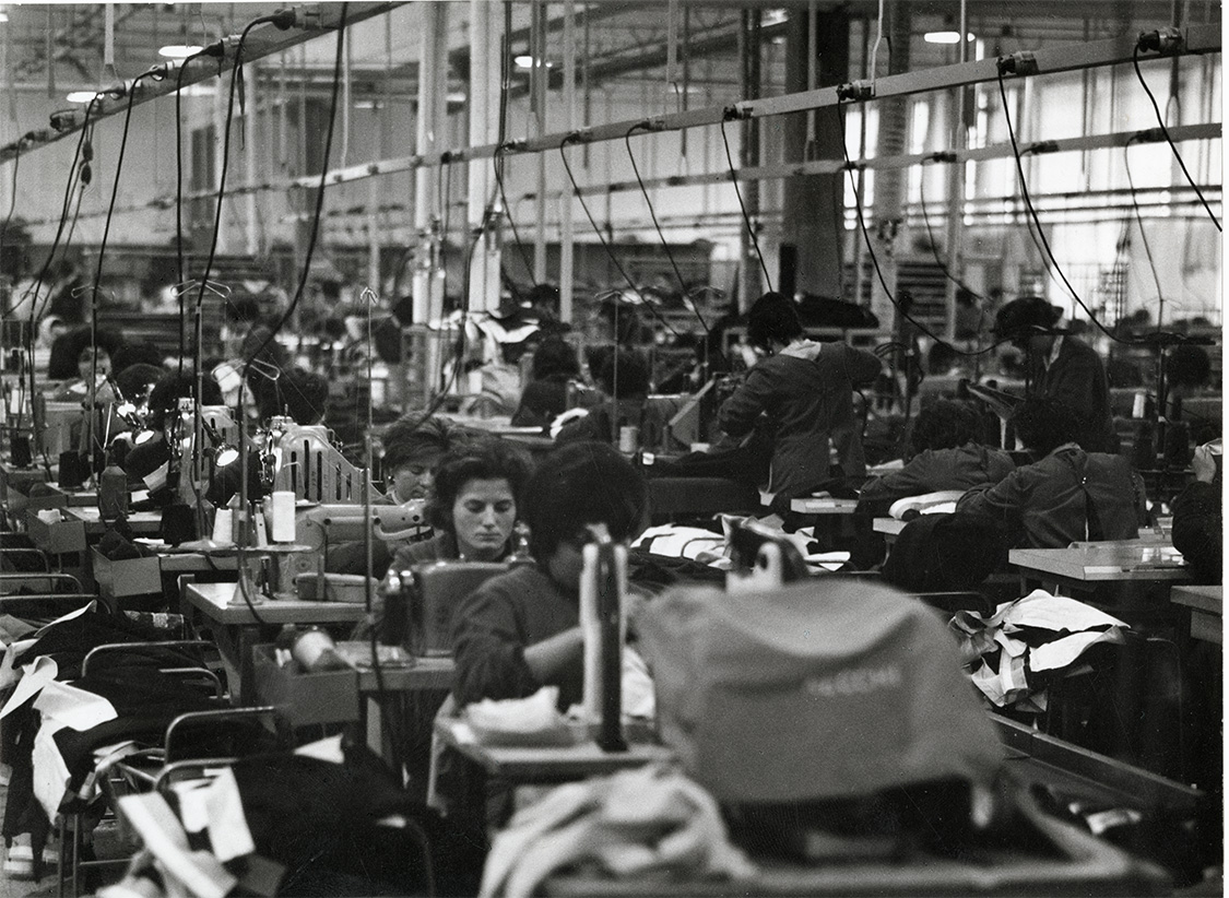 Historical garment factory interior showing clothing manufacturing standards evolution