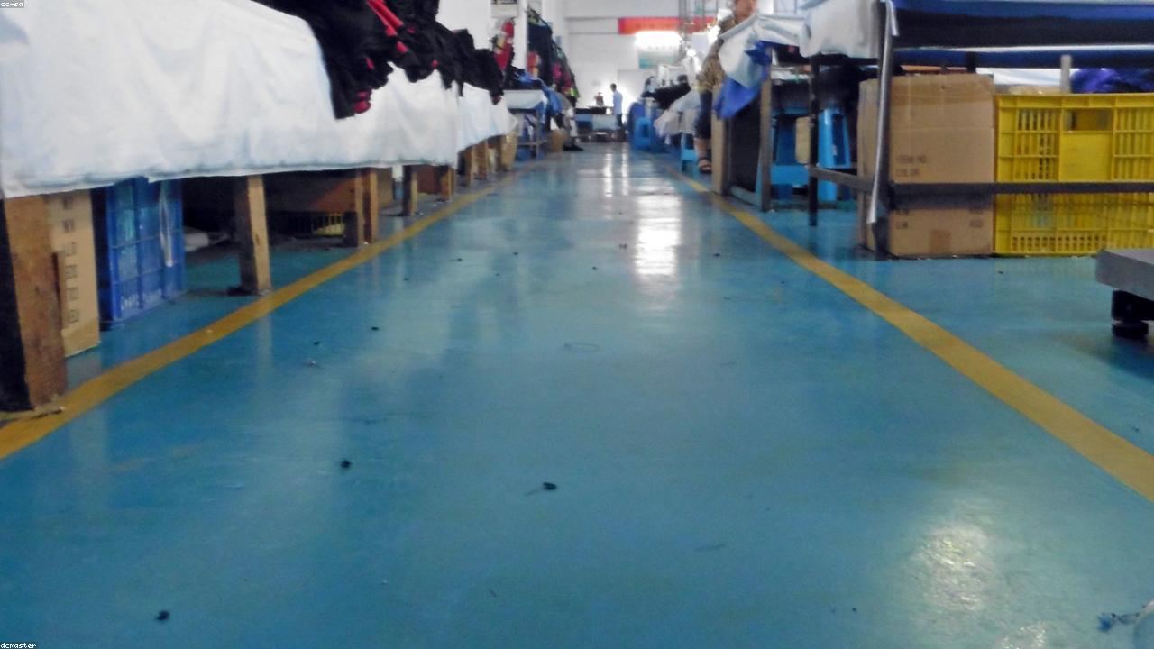 Clothing production line in a garment factory assembling streetwear garments for bulk orders