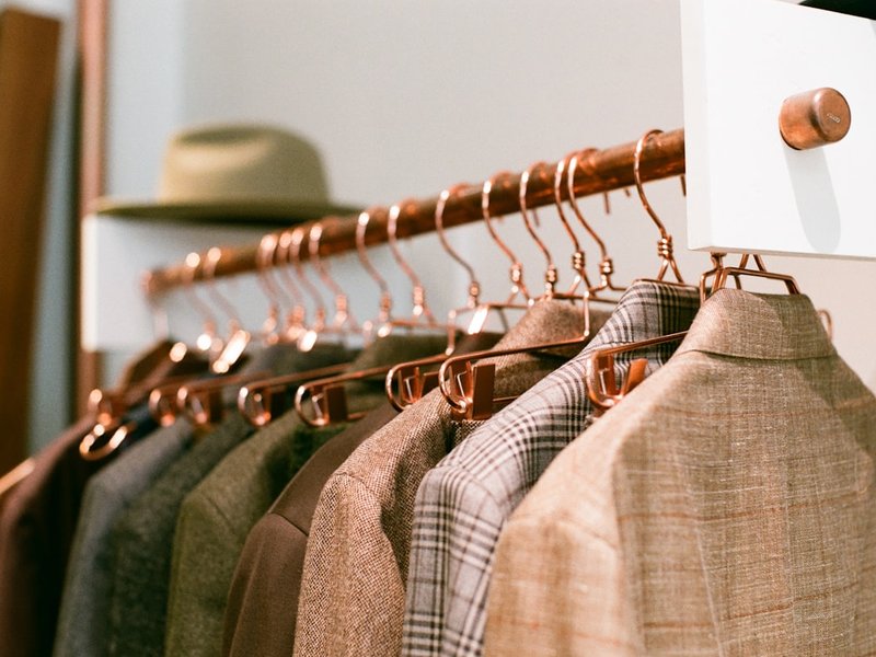 Rack of tailored mens jackets in wool and plaid fabrics
