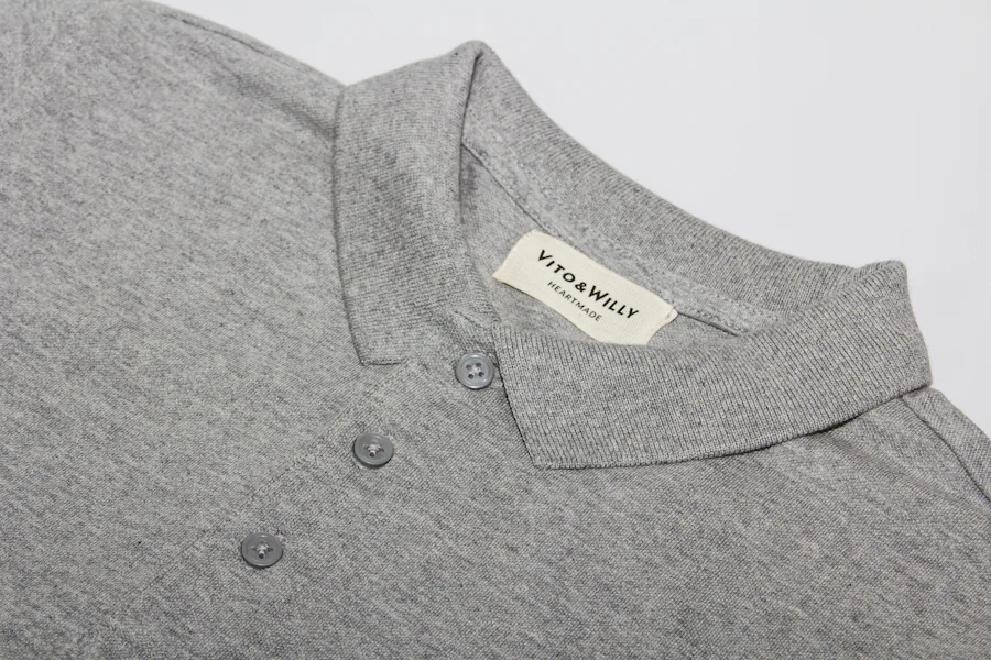 Polo shirt collar and two-button placket construction detail on pique knit fabric