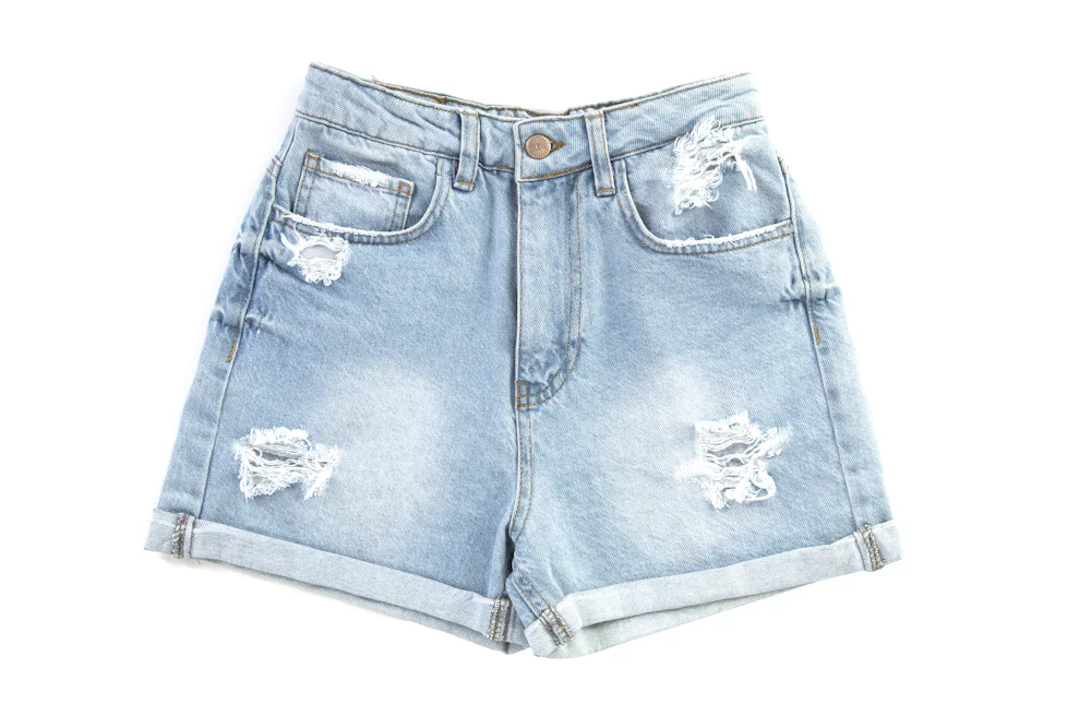 Distressed denim shorts proto sample laid flat for construction and wash evaluation