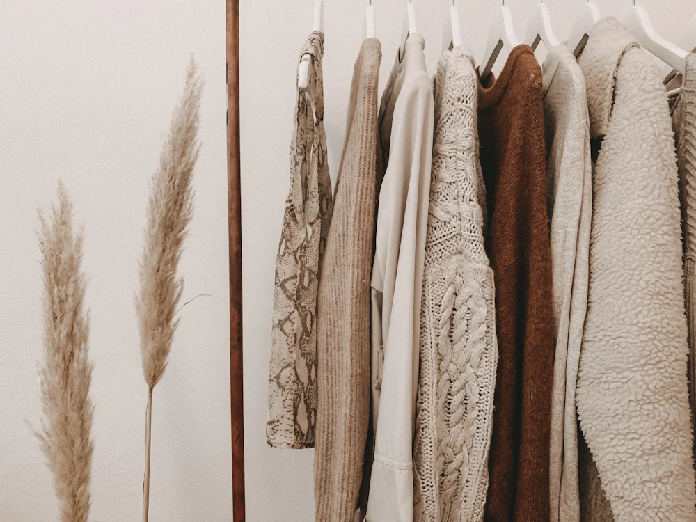 Rack of knitwear and outerwear samples hanging in a manufacturer's sample development room
