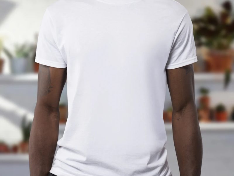 Model wearing a plain white fit sample t-shirt during a garment sampling fit review
