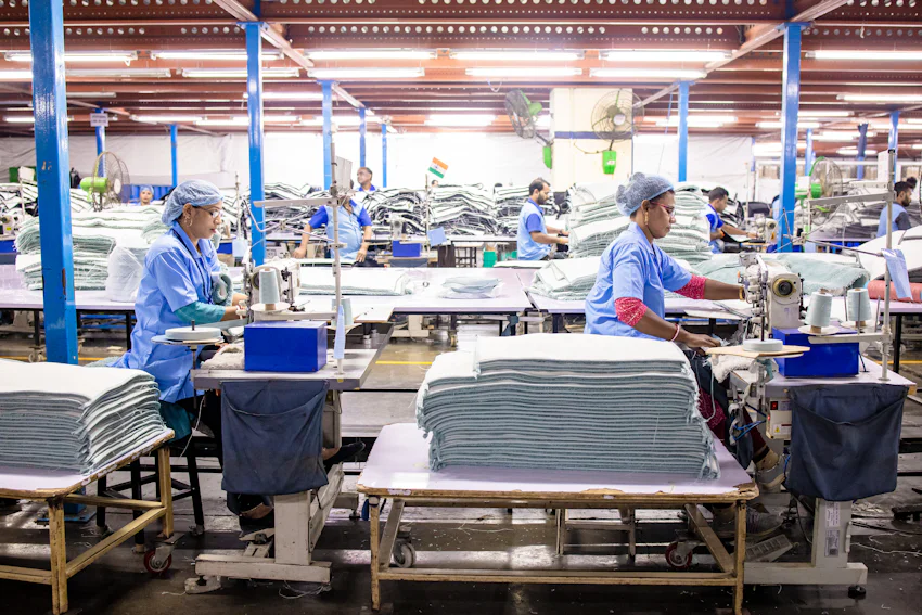 Cut fabric panel stacks ready for assembly at a small batch clothing manufacturer facility