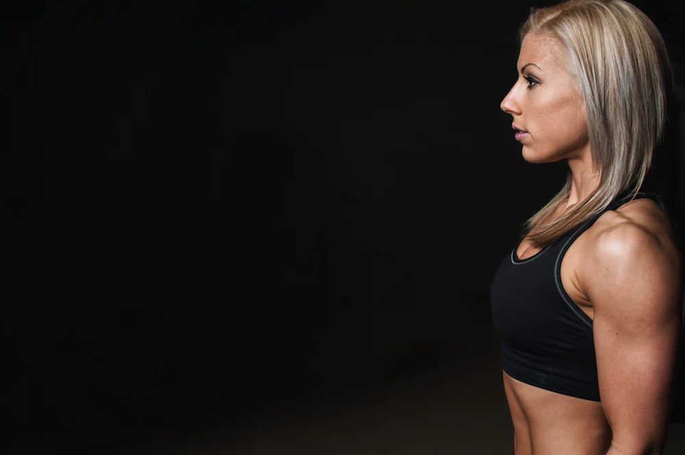 Woman wearing a racerback sports bra showing shoulder strap construction from a sports bra manufacturer