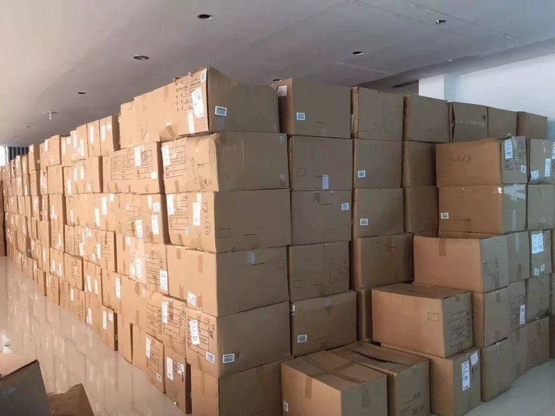 Stacked cardboard shipping cartons ready for export in a warehouse