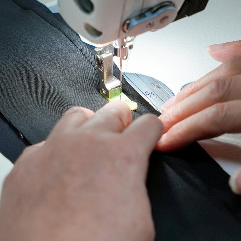 Sewing machine operator finishing a sample for a startup clothing manufacturer order