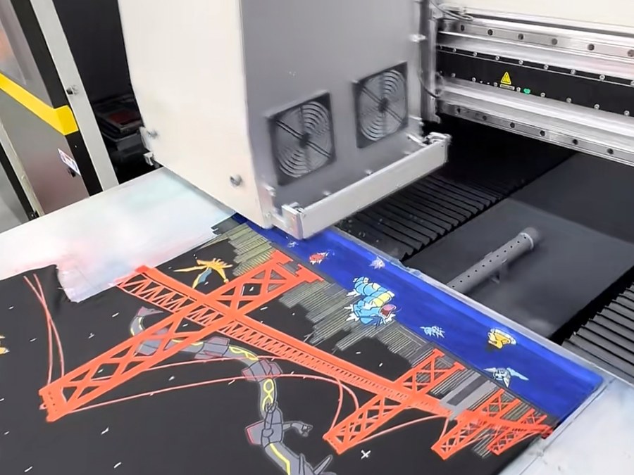 Digital printer laying down an all-over graphic panel at a streetwear manufacturer
