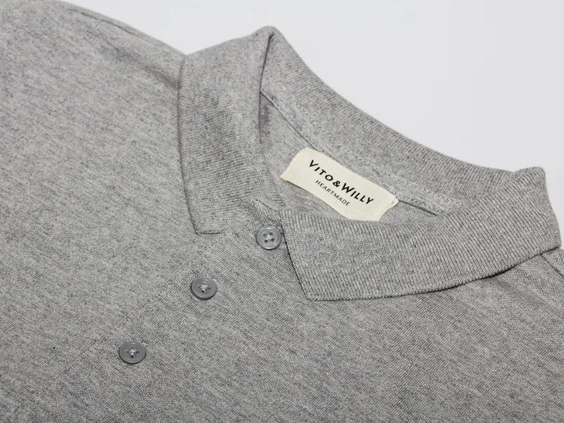 Close-up of a polo collar construction and button placket showing tech pack specification detail
