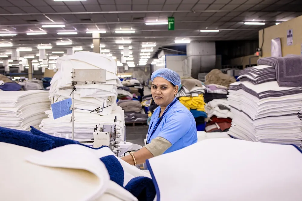 Folded brushed knit fabric staged at a thermal base layer manufacturer's production floor