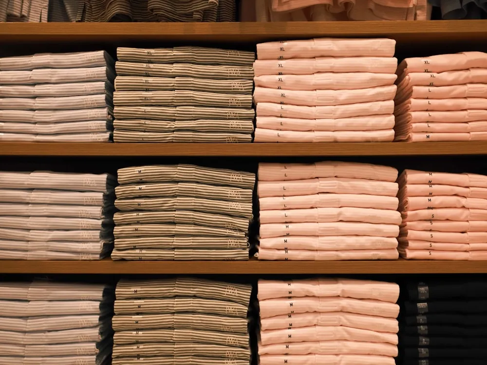 Thermal base layer tops graded and folded by size ahead of bulk shipment
