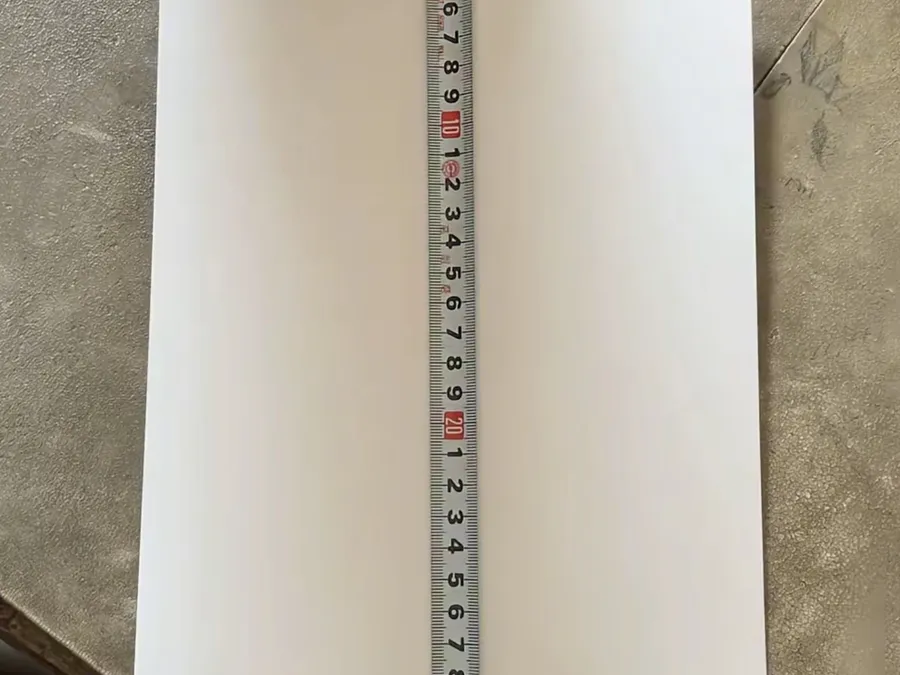 Pattern paper measured against a steel tape during apparel size grading at PRP Apparel's Dongguan factory