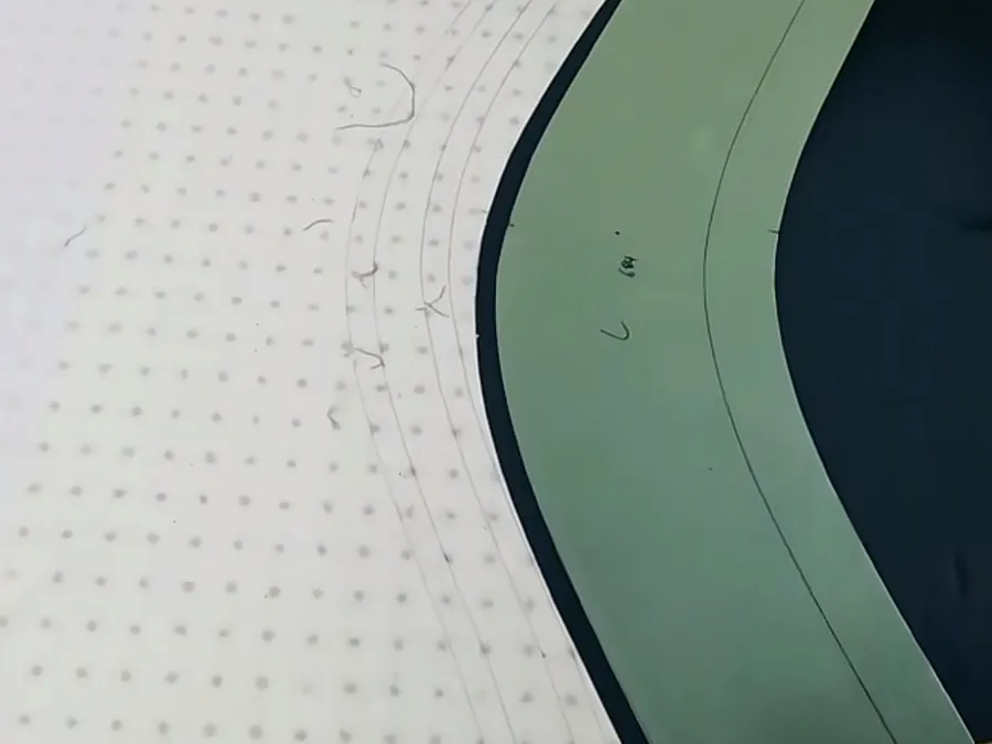 Graded pattern piece showing nested curve lines used for apparel size grading across a size run