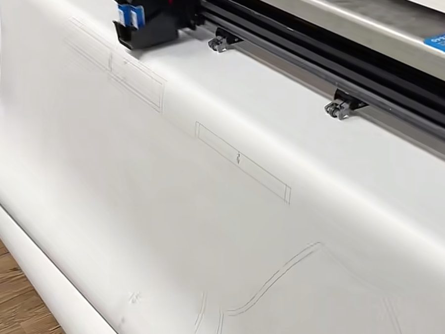 Smooth bamboo-blend fabric on the digital cutting table before pattern cutting