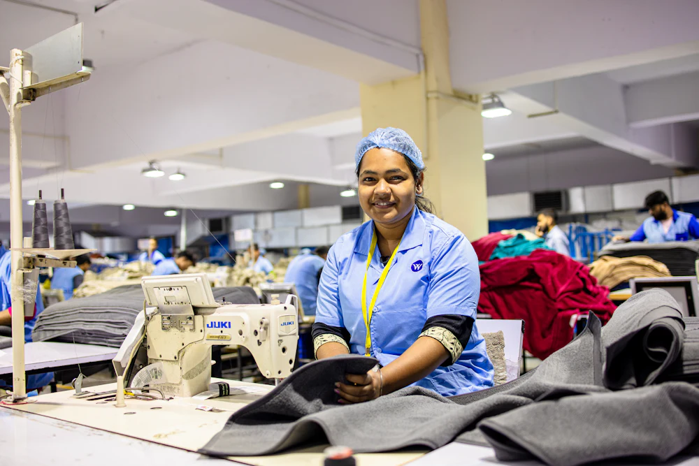 Garment worker at a sewing station on a bralette manufacturer's factory floor