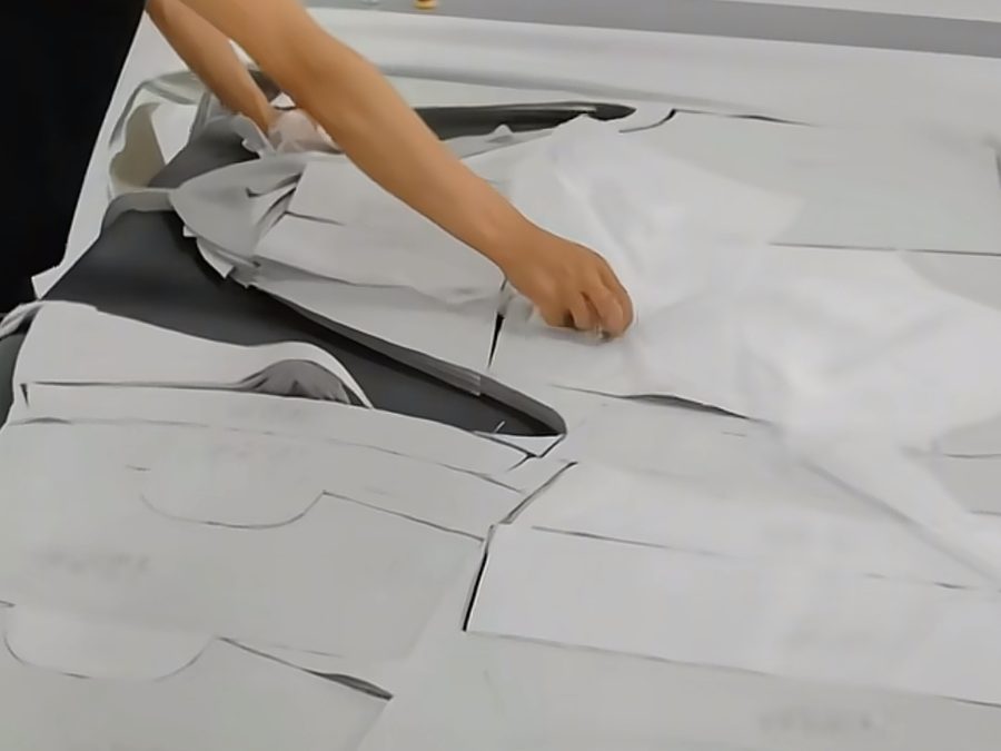 Pattern pieces laid out on the cutting table during bulk clothing production