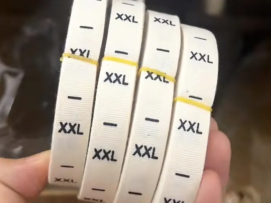 Woven size labels produced in-house at PRP Apparel's Dongguan factory alongside care label runs