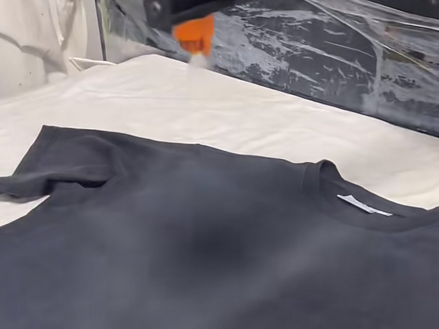 DTG printer applying a design during the clothing manufacturing printing process