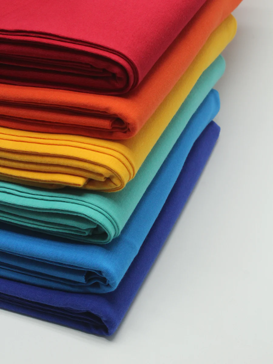 Stacked colorway fabric swatches used to verify a mill's dye lot during fabric sourcing