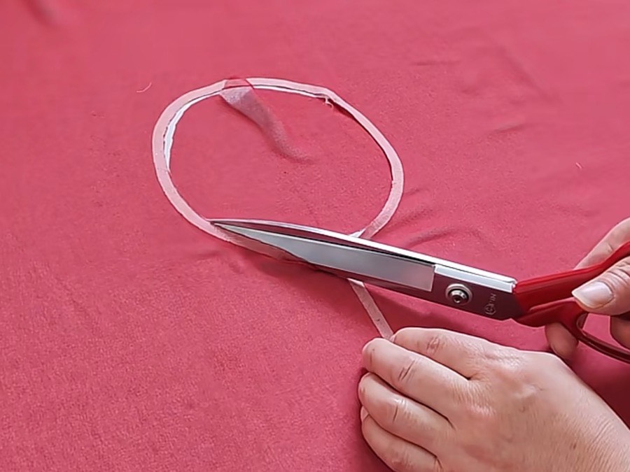 Hand-trimming a cut edge during in-line quality control at PRP Apparel