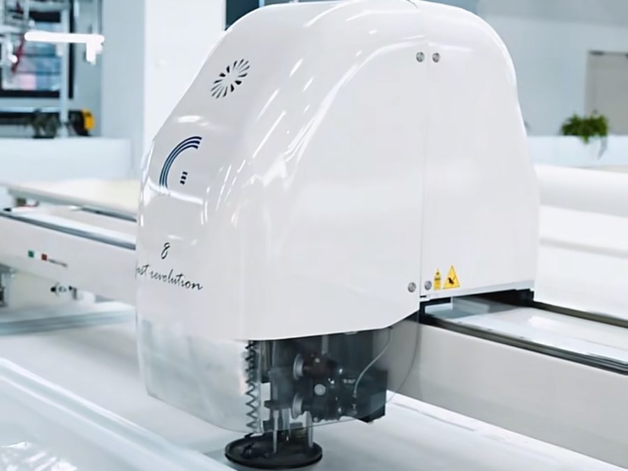 Digital CAD cutting machine cutting fabric panels for consistent hospitality uniform sizing