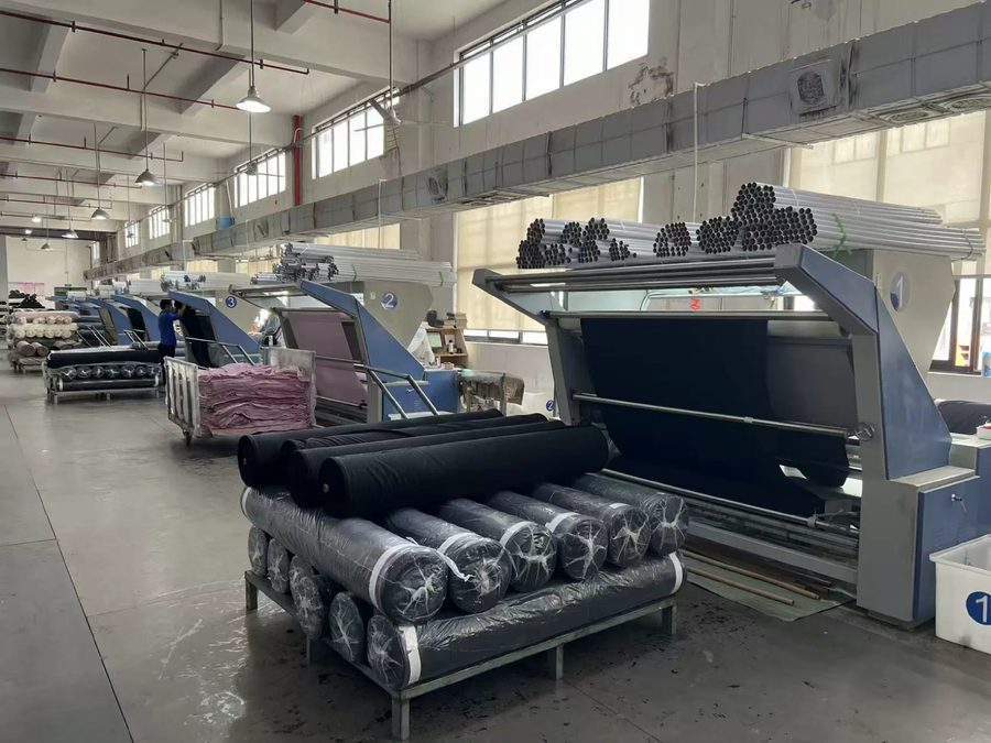Jersey knit fabric rolls on the inspection line before cutting