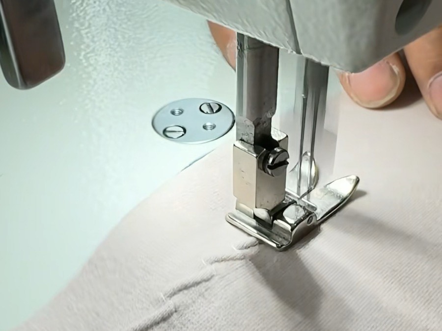 A PRP Apparel sewing operator guiding fabric through a flatlock machine