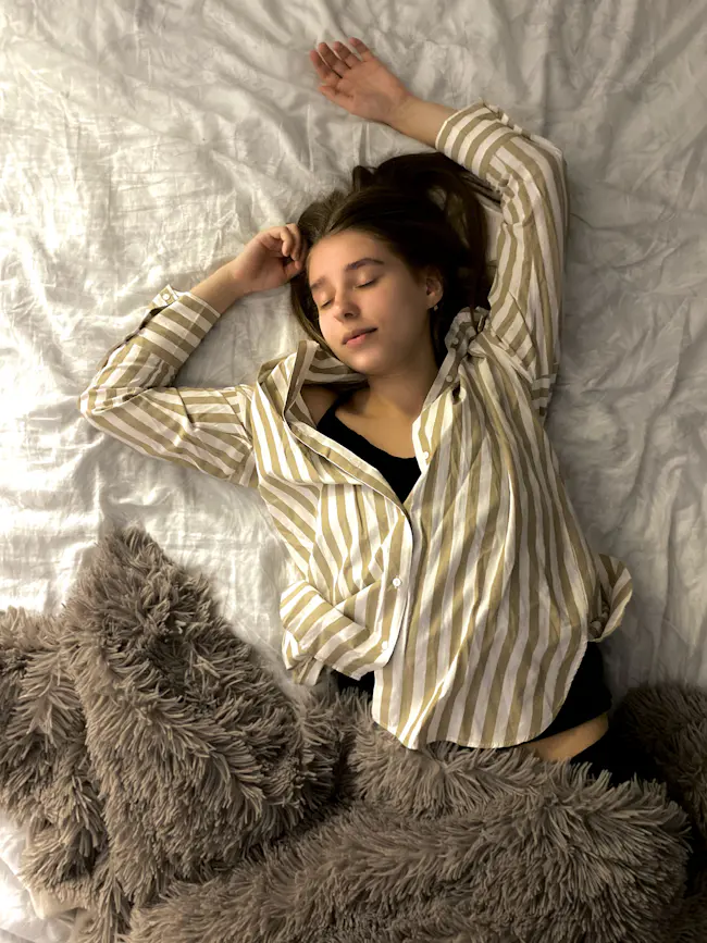 Oversized button-front sleep shirt worn as sleepwear, showing the loose silhouette a sleep shirt manufacturer needs to grade correctly