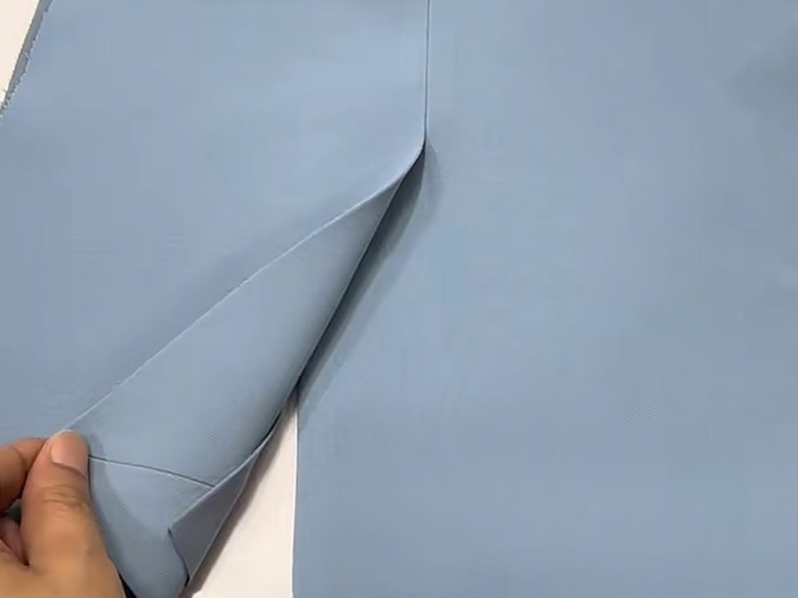 Four-way stretch performance fabric checked for recovery before cutting