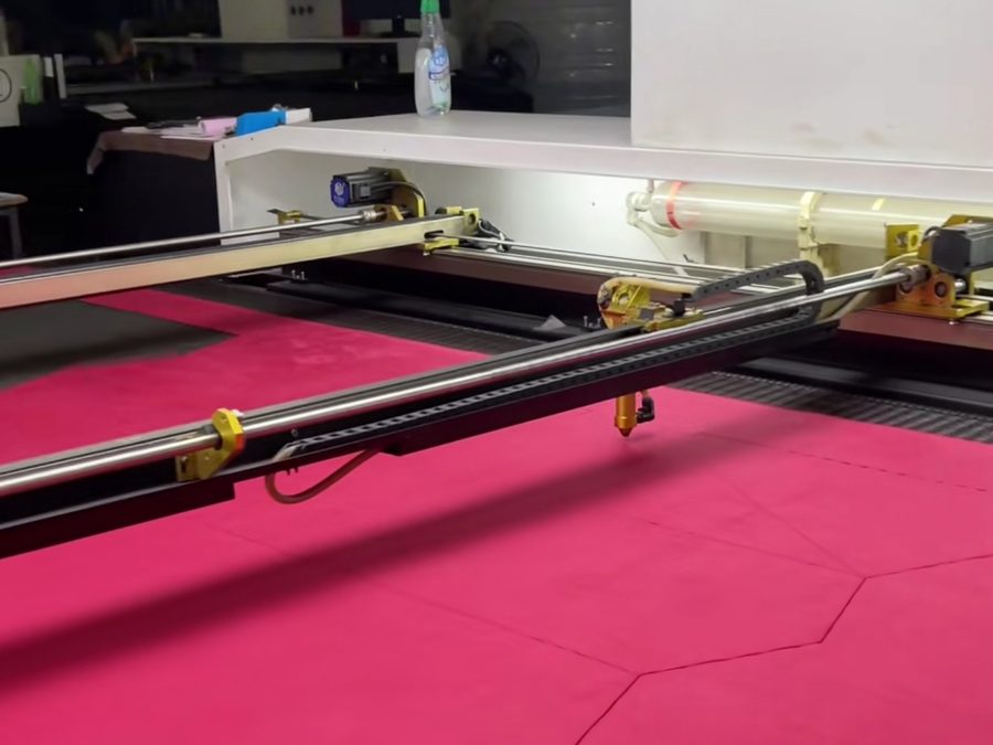 Laser-guided cutting table cutting heavyweight fabric for an oversized streetwear block