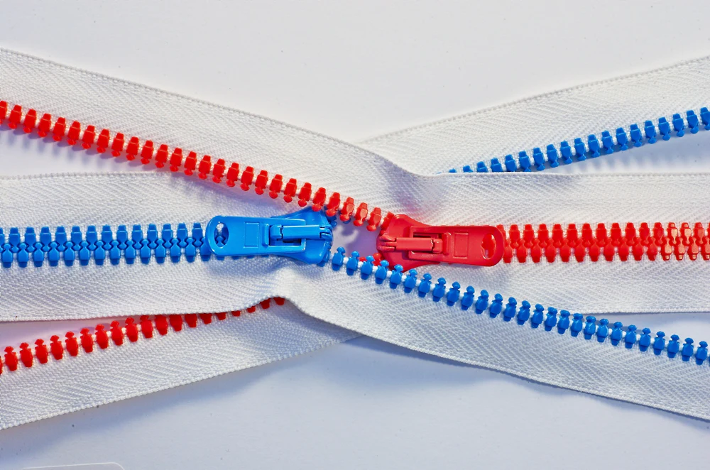 Coil zipper tape in two colorways, the kind of trim detail a clothing manufacturer sources separately from fabric