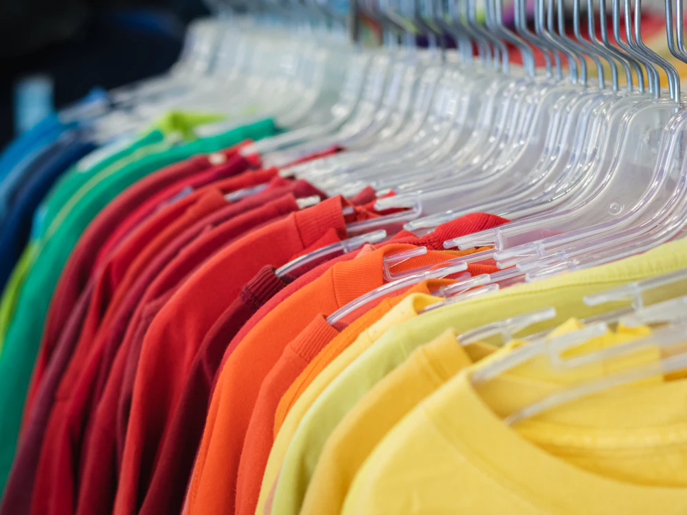 Rack of women's fitted t-shirt colorways ready for bulk production at a Dongguan factory