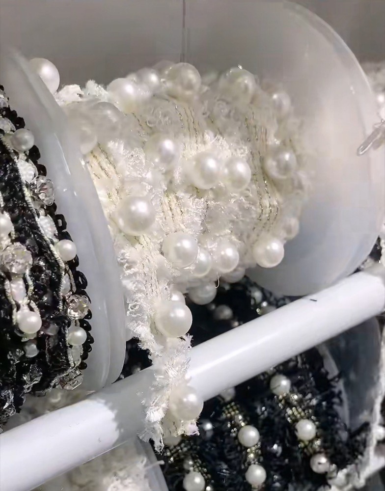 Reels of pearl and bead trim, white tweed-style braid with large pearls and black braid with small beads
